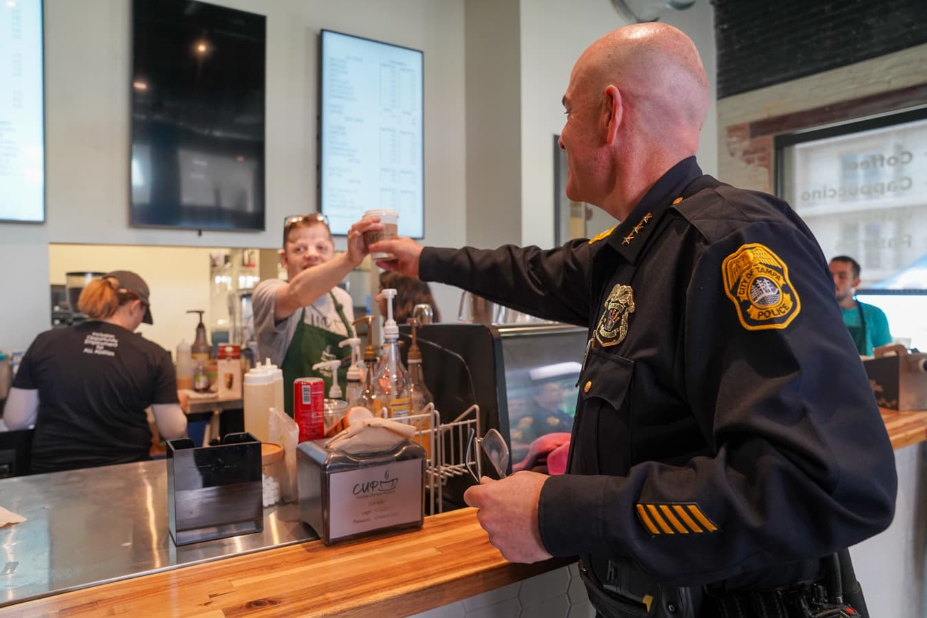 Tampa Police Chief receiving coffee from a CUP barista at the Downtown EMBARC bar