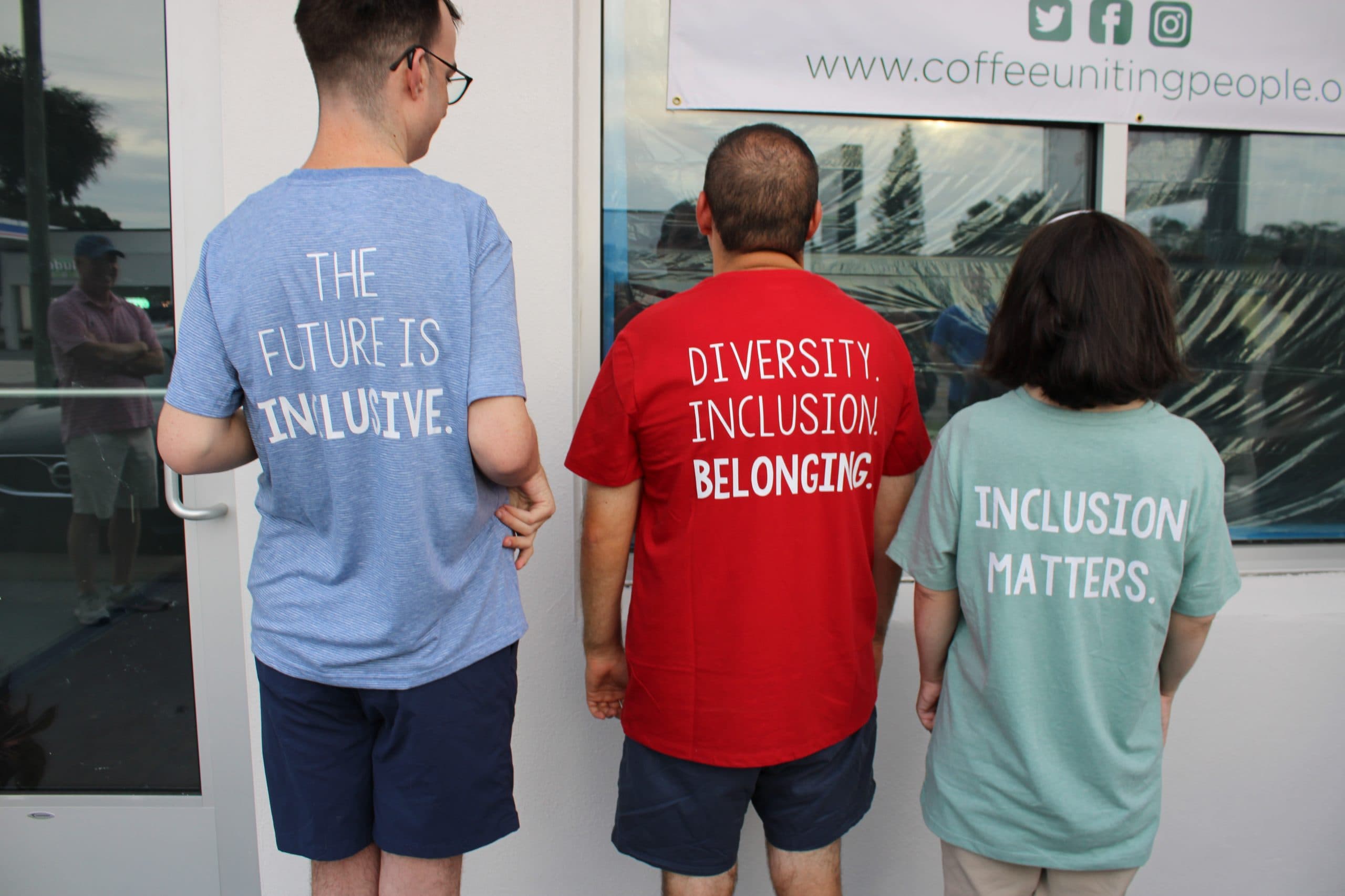 Three CUP team members from behind in 'The Future Is Inclusive' shirts